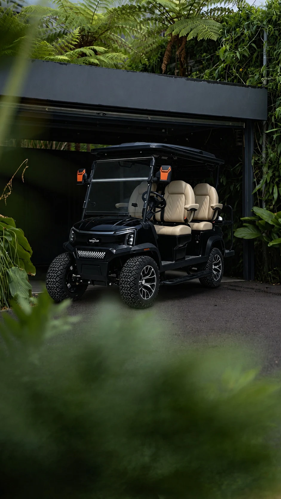 Cortéa Apex luxury electric golf cart in deep green outside modern architecture